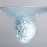 Close-up of a fizzy bath bomb dropped in water